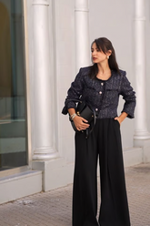 a lady in a sequin jacket and a pair of black wide leg pants